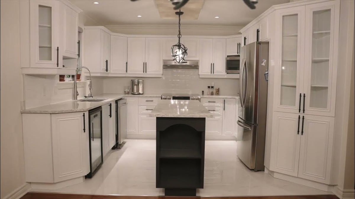 A picture of a residential home kitchen that has painted cabinets