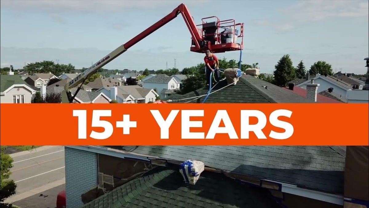 A picture of a residential home roof getting sprayed with a roof regranulation coating